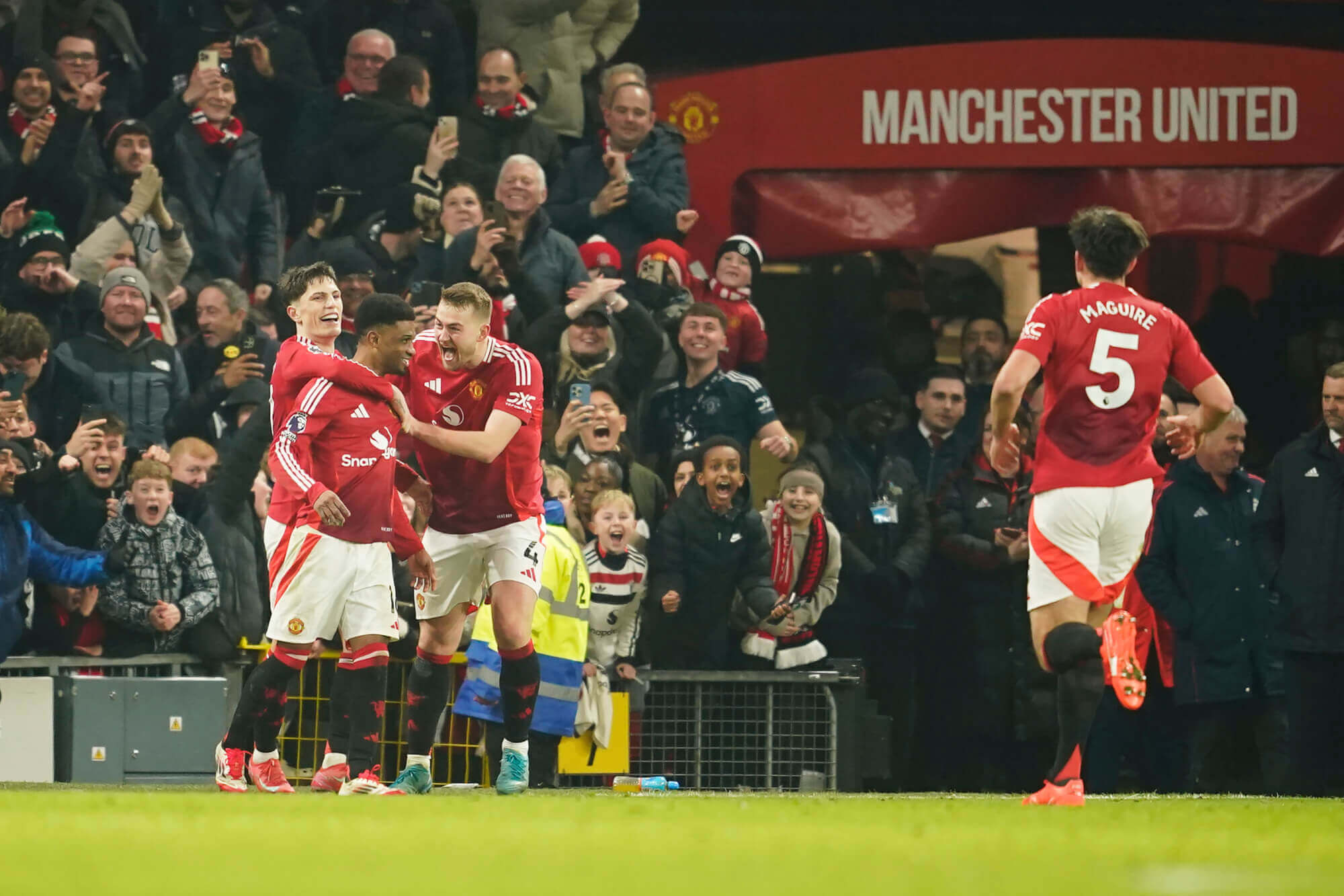 Manchester United players celebrate Amad goal